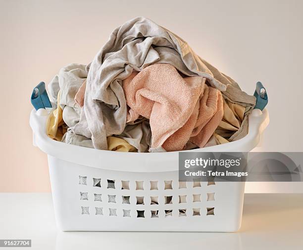 a laundry basket full of clothes - laundry basket fotografías e imágenes de stock