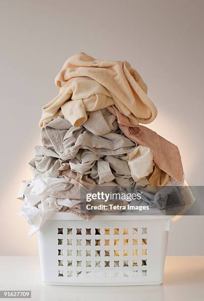 a laundry basket full of clothes - empty laundry basket stock pictures, royalty-free photos & images