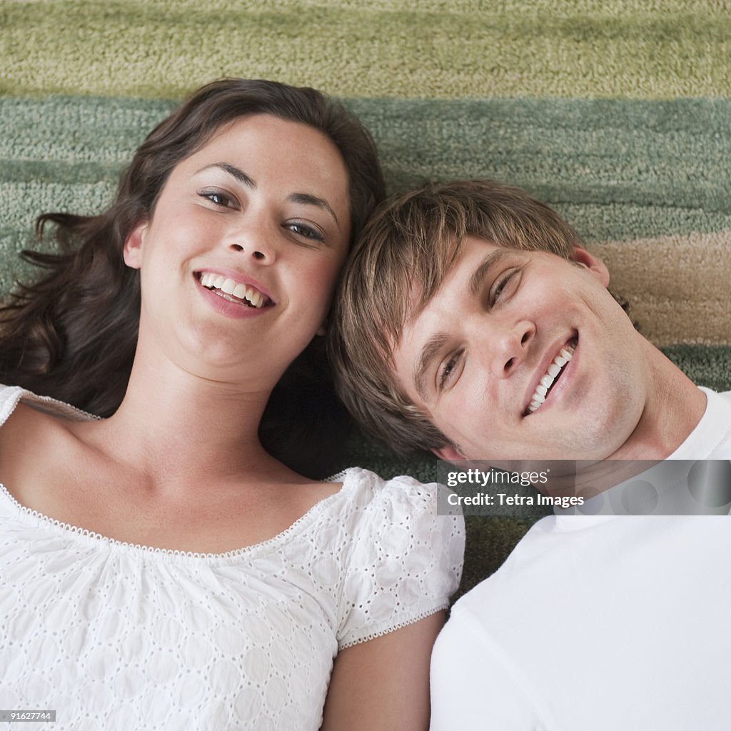 Couple lying in living room