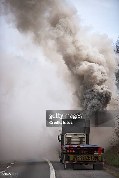 large semi truck emitting exhaust fumes - truck smog stock pictures, royalty-free photos & images