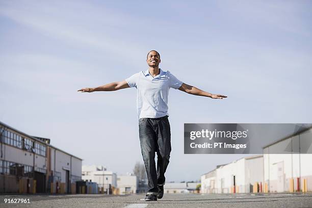 a man walking the line on a road - alameda california stock-fotos und bilder