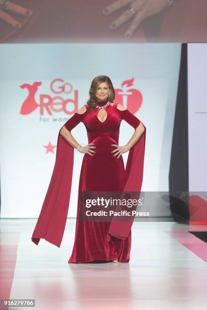 Kathy Ireland wearing gown by Marc Bouwer walks runway for Red Dress 2018 Collection Fashion Show at Hammerstein Ballroom.