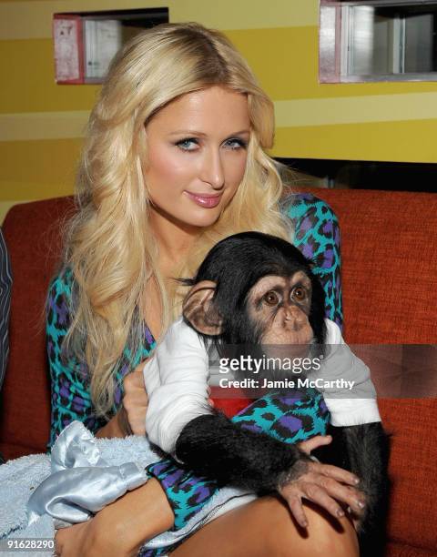 Paris Hilton with Bentley the Chimpanzee attends the opening of Carnival at Bowlmor Lanes on October 8, 2009 in New York City.