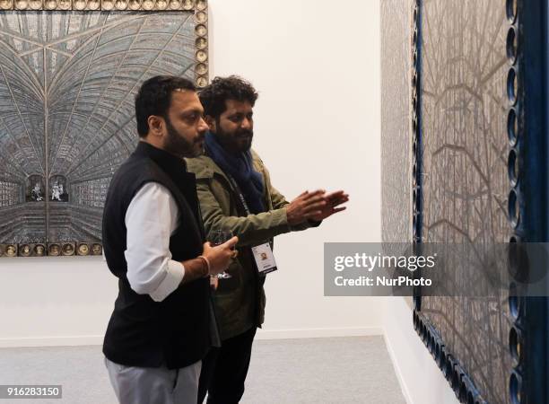 Spectators reflect on art installations at the India Art Fair 2018 at the Okhla NSIC grounds in New Delhi on February 9th, 2018. The annual fair...