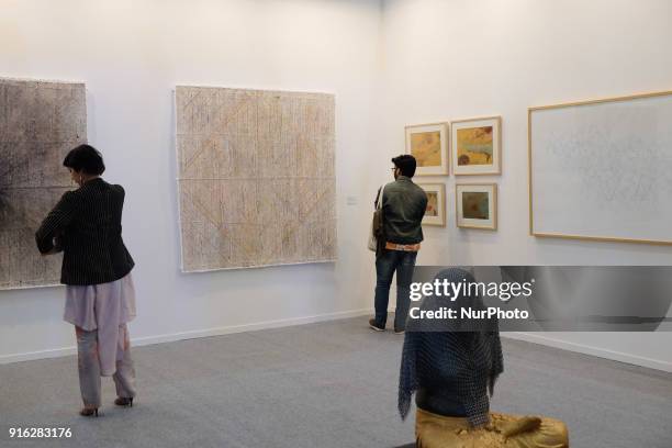 Spectators enjoy paintings and art installations at a booth curating Bombay-based artists at the India Art Fair 2018 held on the Okhla NSIC grounds...