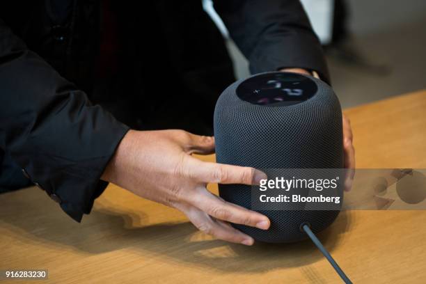 Customer picks up the HomePod speaker on the first day of sales at an Apple Inc. Store in New York, U.S., on Friday, Feb. 9, 2018. Apple Inc.'s...