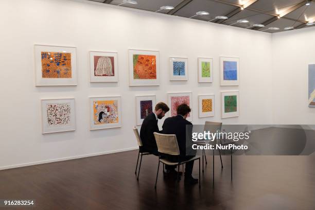 Artist representatives sit at installation booths at the India Art Fair 2018 held on the Okhla NSIC grounds in New Delhi on February 9th, 2018. The...