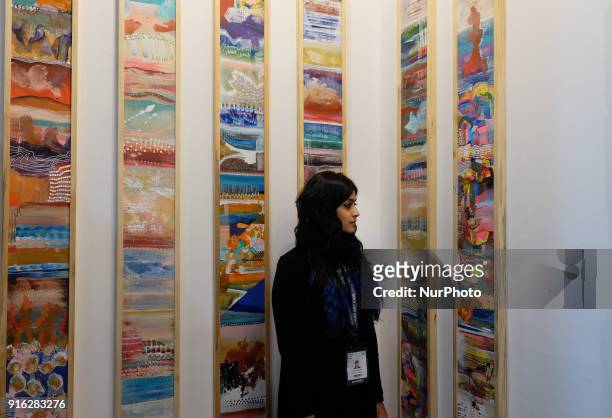 Artist Sahaya Sharma stands in front of her installation of acrylic and sequins on wooden panels called &quot;Decorative Wound Series&quot; at the...