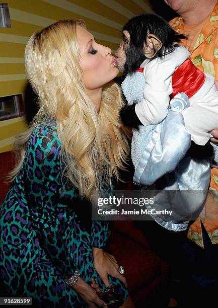 Paris Hilton with Bentley the Chimpanzee attends the opening of Carnival at Bowlmor Lanes on October 8, 2009 in New York City.