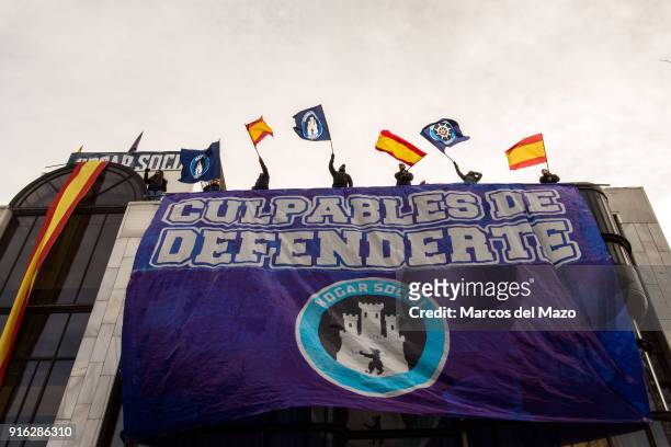 Members of far right group Hogar Social Madrid wave flags in the rooftop of occupied building as police arrives for their eviction, which finally has...