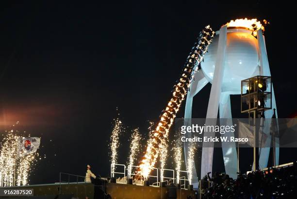 Winter Olympics: View of South Korea figure skater Kim Yuna at cauldron with Olympic Flame during torch lighting at PyeongChang Olympic Stadium....