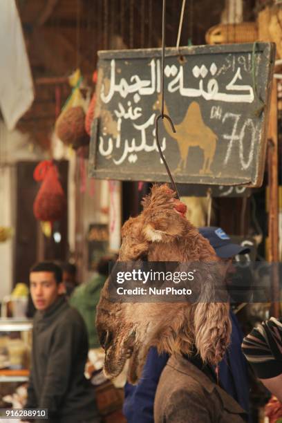 The head of a camel hangs by a shop selling camel meat in Fez in Morocco, Africa.