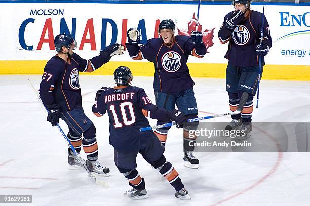 Denis Grebeshkov, Shawn Horcoff, Ales Hemsky and Tom Gilbert of the Edmonton Oilers celebrate a third period goal against the Calgary Flames on...