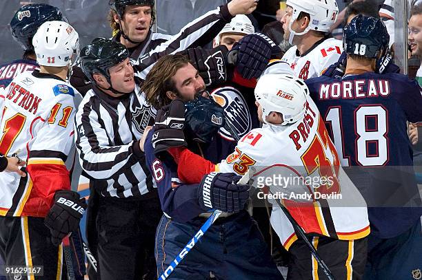 Brandon Prust of the Calgary Flames and Zack Stortini of the Edmonton Oilers shove during a scrum on October 8, 2009 at Rexall Place in Edmonton,...