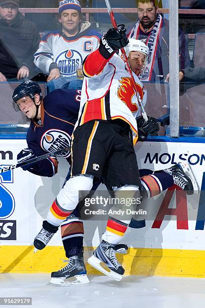 Jarome Iginla of the Calgary Flames lays a bodycheck on Ales Hemsky of the Edmonton Oilers on October 8, 2009 at Rexall Place in Edmonton, Alberta,...