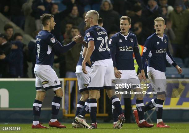 Lee Gregory of Millwall celebrates after scoring his sides first goal with his team mates during the Sky Bet Championship match between Millwall and...