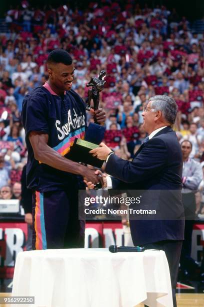 David Robinson of the San Antonio Spurs is presented the MVP Trophy by NBA Commissioner David Stern during Game Two of the Conference Finals of the...