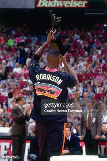 David Robinson of the San Antonio Spurs is presented the MVP Trophy during Game Two of the Conference Finals of the 1995 NBA Playoffs played on May...