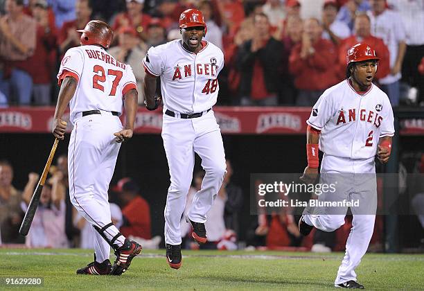 Torii Hunter of the Los Angeles Angels of Anaheim celebrates with teammates Vladimir Guerrero and Erick Aybar after hitting a three-run home run as...