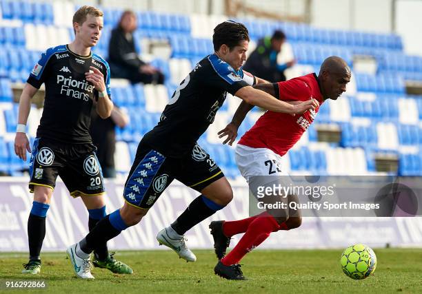 Luiz Muriqui of Meizhou Meixian is tackled by David Wiklander of Goteborg during the friendly match between IFK Goteborg and Meizhou Meixian at...