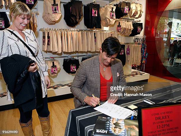 Celebrity Plastic Surgeon Dr Robert Rey signs a note for Amy Jo Connolly during an appearance to launch the Shapewear range at Target on October 9,...