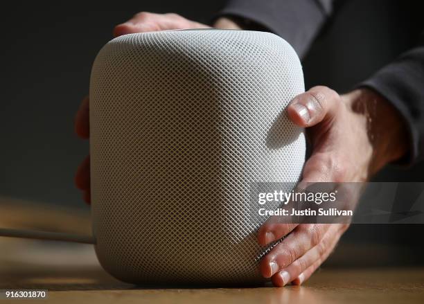 Customers inspect the new Apple HomePod at an Apple Store on February 9, 2018 in San Francisco, California. Apple's new HomePod went on sale today at...