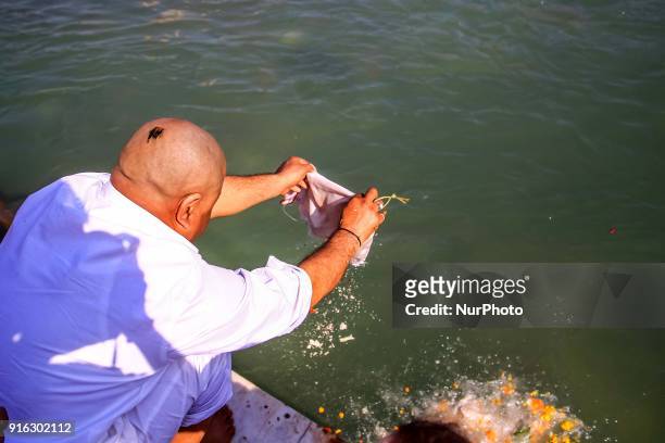 Man immersion ashes of his ancestor into ganga river in Haridwar, Uttrakhand, India on 8th Feb ,2018.According to hindu culture Har ki Pauri one of...