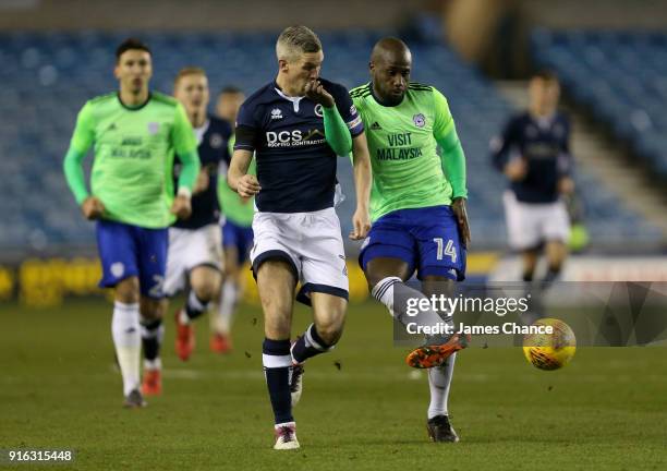 Sol Bamba of Cardiff City is challenged by Steve Morison of Millwall during the Sky Bet Championship match between Millwall and Cardiff Cityat The...