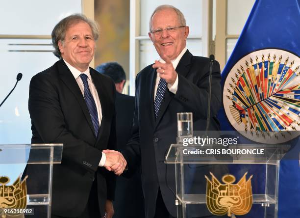 The Secretary General of the Organization of American States , Luis Almagro , and Peruvian President Pedro Pablo Kuczynski shake hands while...