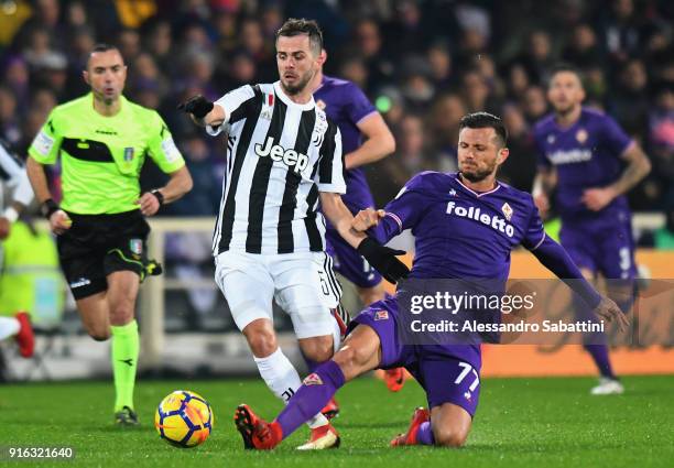 Miralem Pjanic of Juventus competes for the ball whit Cyril Thereau of ACF Fiorentina during the serie A match between ACF Fiorentina and Juventus at...