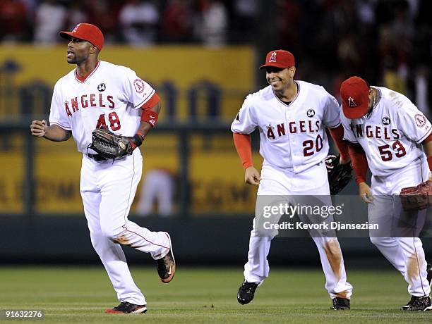 Torii Hunter of the Los Angeles Angels of Anaheim celebrates with teammates Juan Rivera and Bobby Abreu after their 5-0 victory over the Boston Red...