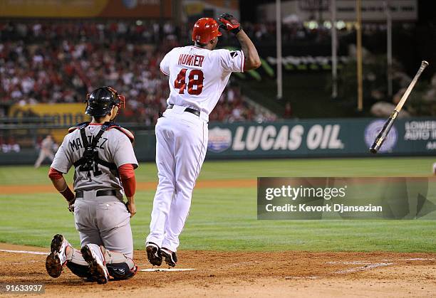 Torii Hunter of the Los Angeles Angels of Anaheim reacts to hitting a three-run home run as catcher Victor Martinez of the Boston Red Sox look on in...