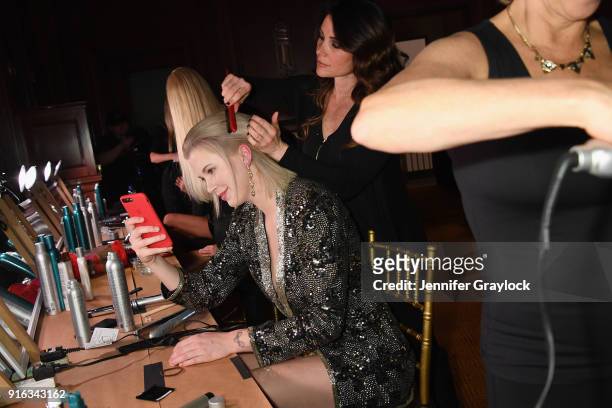 Model Ireland Baldwin prepares backstage during the NYFW Sherri Hill Runway Show on February 9, 2018 in New York City.
