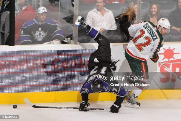 Wayne Simmonds of the Los Angeles Kings is checked by Cal Clutterbuck of the Minnesota Wild on October 8, 2009 at Staples Center in Los Angeles,...
