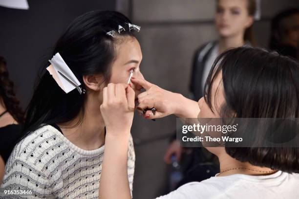 Model prepares backstage for Matthew Adams Dolan during New York Fashion Week presented by Made at Gallery II at Spring Studios on February 9, 2018...