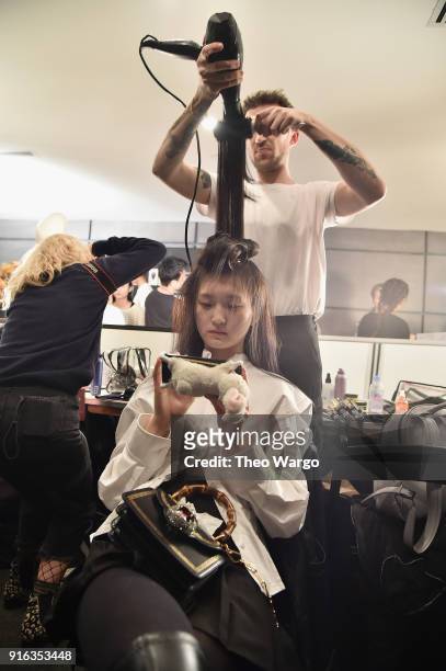 Model prepares backstage for Matthew Adams Dolan during New York Fashion Week presented by Made at Gallery II at Spring Studios on February 9, 2018...