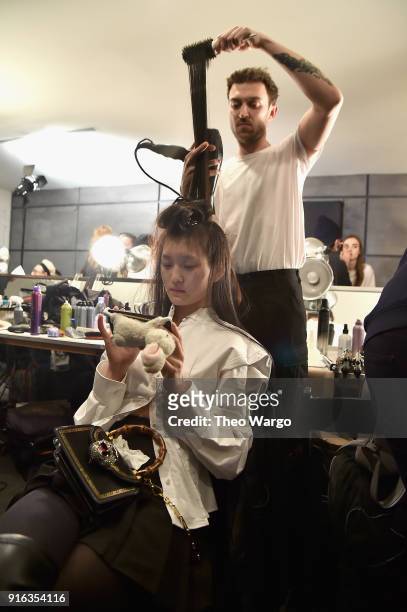 Model prepares backstage for Matthew Adams Dolan during New York Fashion Week presented by Made at Gallery II at Spring Studios on February 9, 2018...