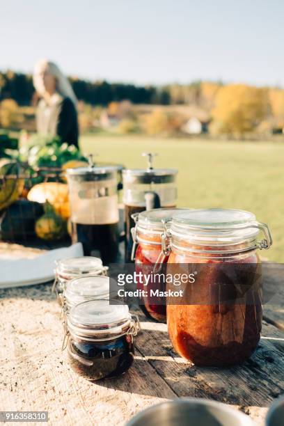 preserves in airtight jars and french press displayed for sale on table at farmers market - preserved stock pictures, royalty-free photos & images