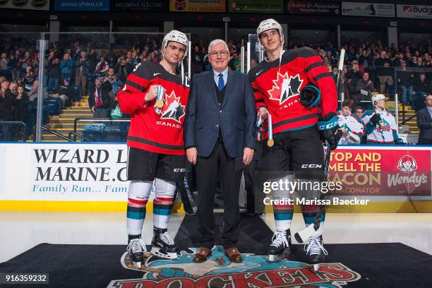 Kelowna Rockets' General Manger Bruce Hamilton stands on the ice between Dillon Dube and Cal Foote of the Kelowna Rockets to acknowledge the gold...