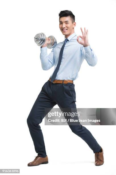 young businessman lifting weights - legs apart imagens e fotografias de stock