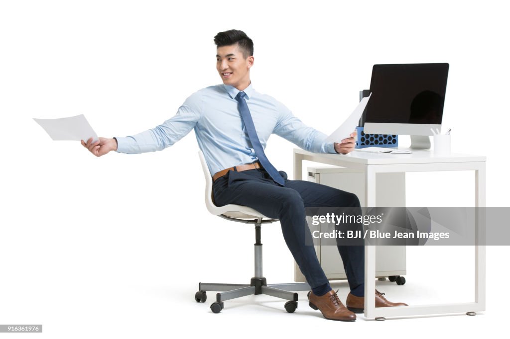 Cheering young businessman working in office