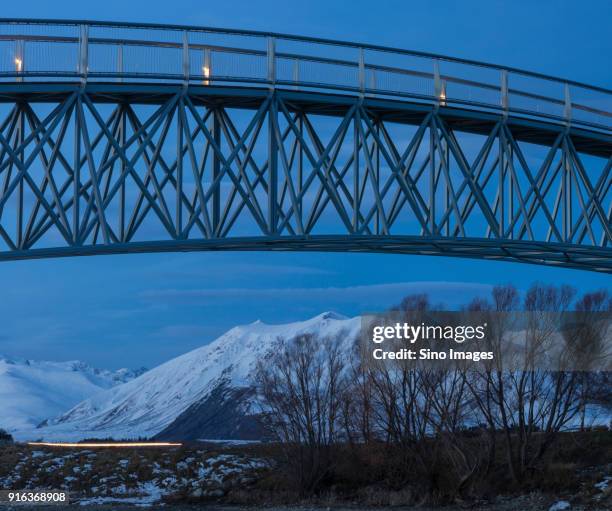 bridge against mountains at dusk, new zealand - new zealand connected fotografías e imágenes de stock