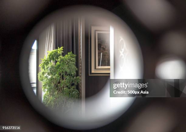 view through peephole into home interior, beijing, china - peephole stock-fotos und bilder