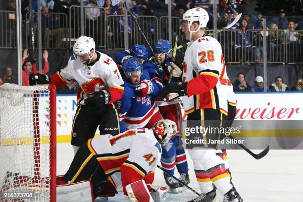 Kevin Hayes, David Desharnais and Jesper Fast of the New York Rangers celebrate after scoring a goal in the first period against Mike Smith of the...