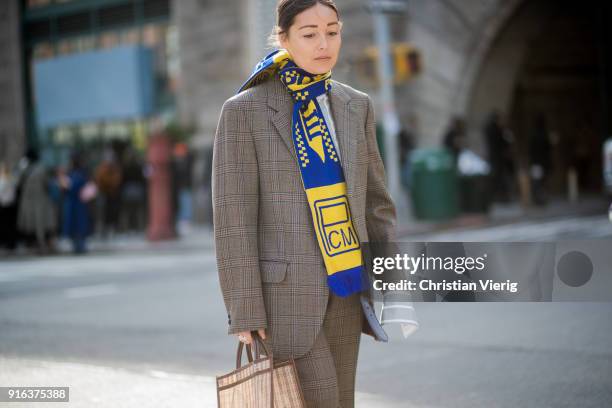 Rachael Wang wearing checked blazer, football scarf seen outside Tory Burch on February 9, 2018 in New York City.