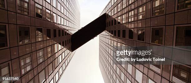 a gateway between two towers - ludovic toinel stock pictures, royalty-free photos & images