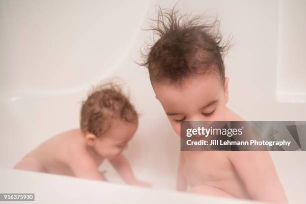 18 month old twin boys with wild hair play in a bathtub together - hair standing on end stock pictures, royalty-free photos & images