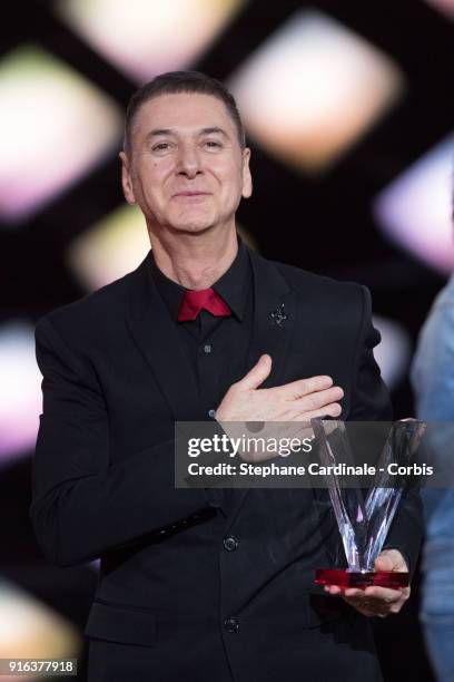 French singer Etienne Daho celebrates after receiving a special Honour Award during the 33rd "Les Victoires De La Musique" at La Seine Musicale on...