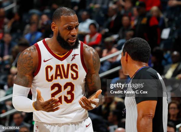 LeBron James of the Cleveland Cavaliers questions a call with referee Bill Kennedy during the game against the Atlanta Hawks at Philips Arena on...