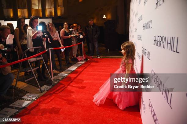 Girl poses on the red carpet during the NYFW Sherri Hill Runway Show on February 9, 2018 in New York City.